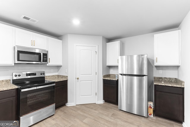 155 Shetland Pines Dr, Macon, GA 31216 - kitchen featuring stainless steel appliances, light wood-type flooring, white cabinetry, light stone counters, and recessed lighting