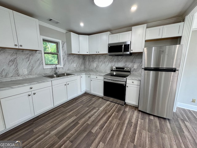 1930 Northbrook Ave, Macon, GA 31201 - kitchen featuring appliances with stainless steel finishes, dark wood-style floors, white cabinets, ornamental molding, and recessed lighting