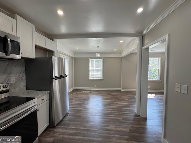 1930 Northbrook Ave, Macon, GA 31201 - kitchen with stainless steel appliances, crown molding, dark wood finished floors, white cabinetry, and tasteful backsplash