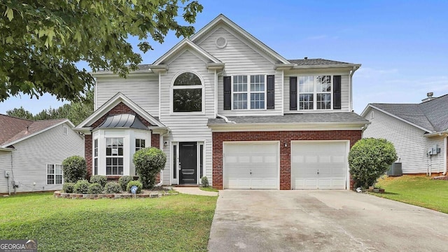 1255 Silverstone Trl, Jonesboro, GA 30238 - traditional-style home with concrete driveway, a front lawn, an attached garage, and brick siding
