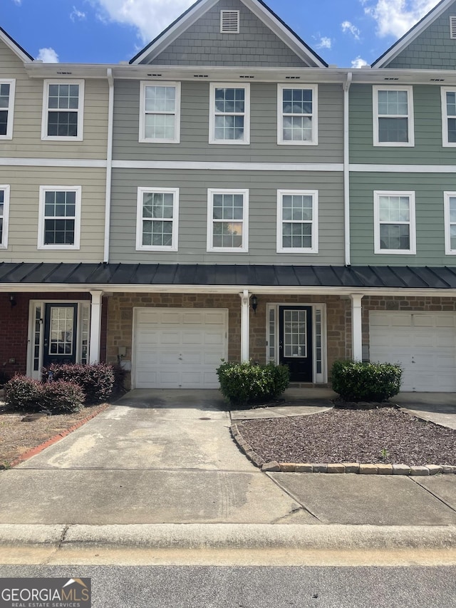 6361 Redan Sq, Lithonia, GA 30058 - townhome / multi-family property with concrete driveway, a garage, and a standing seam roof