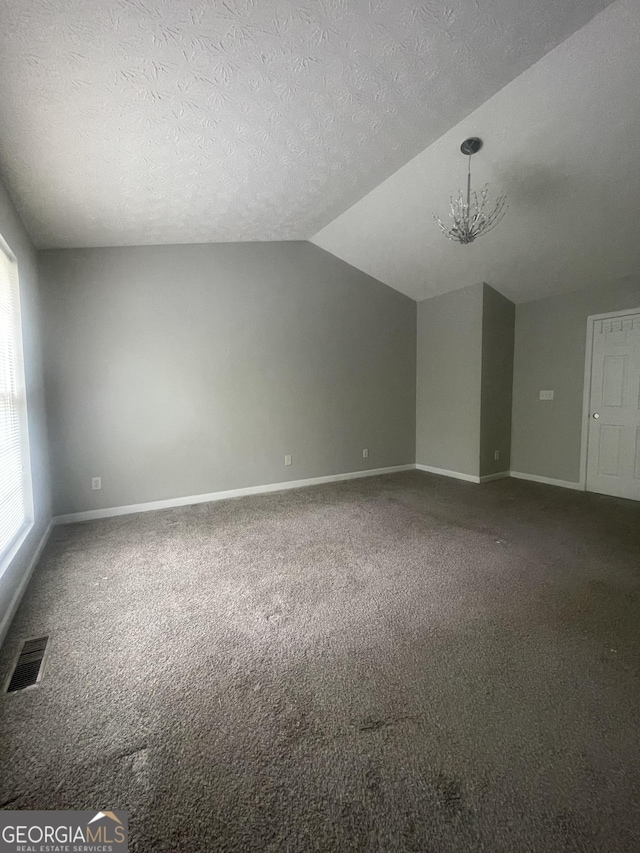 6361 Redan Sq, Lithonia, GA 30058 - bonus room featuring carpet flooring, a chandelier, lofted ceiling, and a textured ceiling
