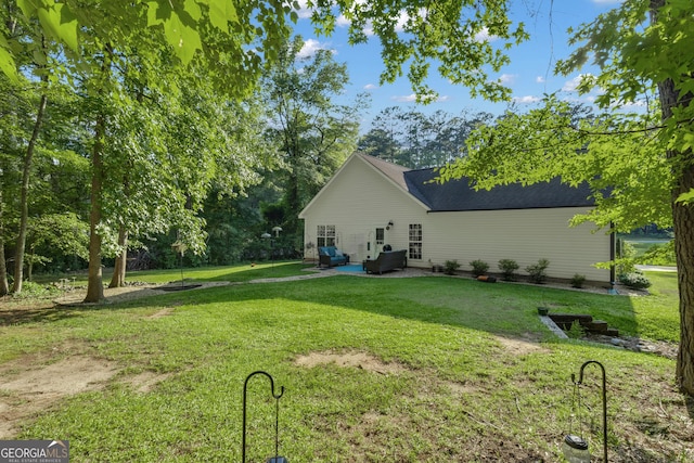 259 Coweta St, Senoia, GA 30276 - rear view of house featuring a lawn, a patio, and a shingled roof