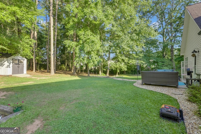 259 Coweta St, Senoia, GA 30276 - view of green lawn with a storage shed, an outdoor living space, and view of scattered trees