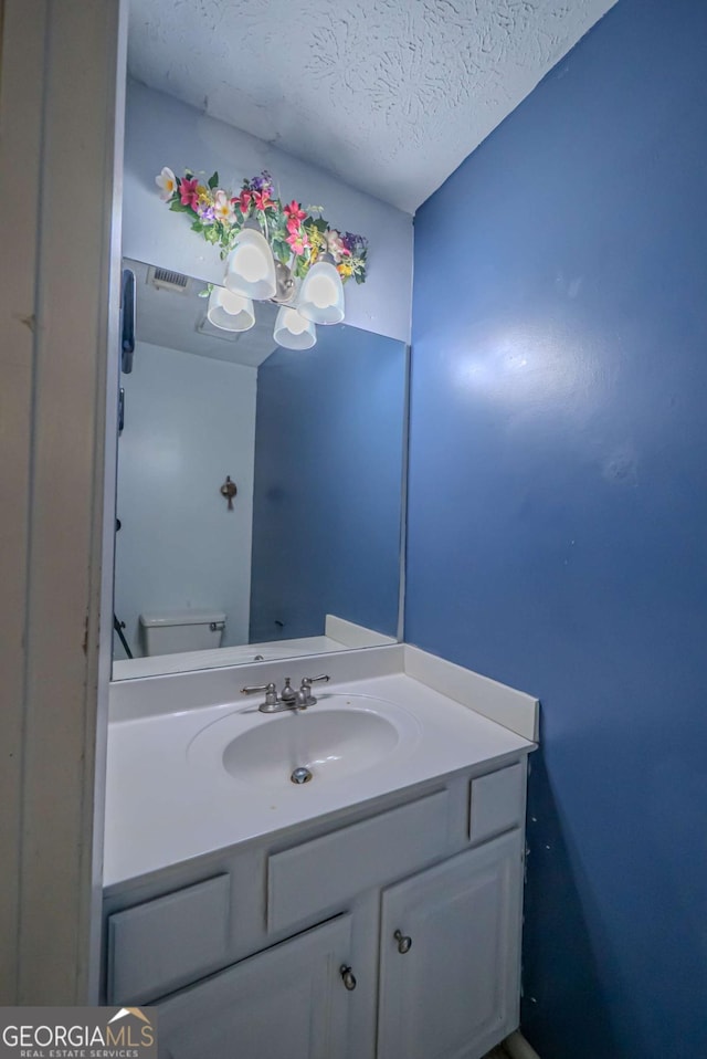 7472 Woods Ct, Lithonia, GA 30058 - bathroom featuring vanity and a textured ceiling