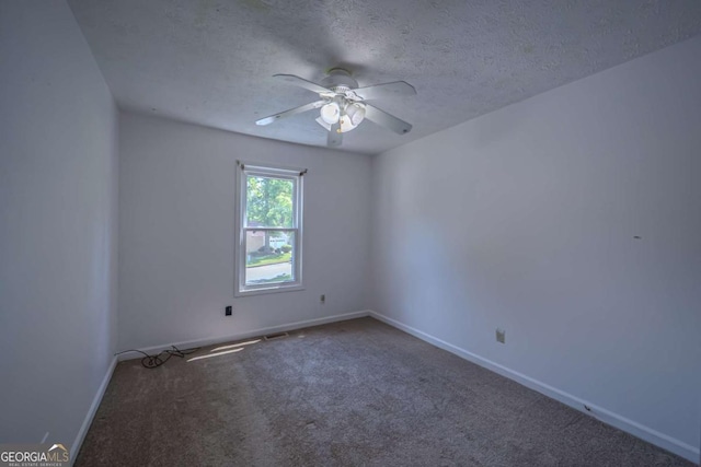 7472 Woods Ct, Lithonia, GA 30058 - spare room featuring a ceiling fan, carpet floors, and a textured ceiling