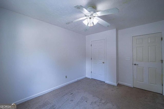 7472 Woods Ct, Lithonia, GA 30058 - unfurnished bedroom with carpet and ceiling fan
