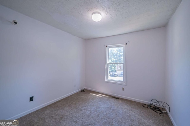 7472 Woods Ct, Lithonia, GA 30058 - carpeted empty room with a textured ceiling and baseboards