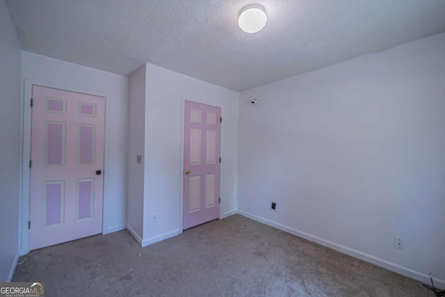 7472 Woods Ct, Lithonia, GA 30058 - unfurnished bedroom featuring carpet flooring and a textured ceiling