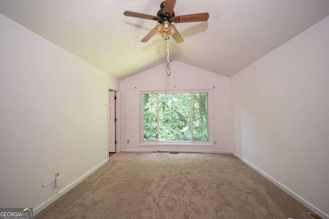 7472 Woods Ct, Lithonia, GA 30058 - spare room with lofted ceiling, carpet floors, and a ceiling fan