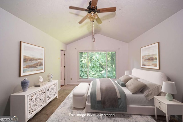 7472 Woods Ct, Lithonia, GA 30058 - carpeted bedroom with vaulted ceiling and a ceiling fan