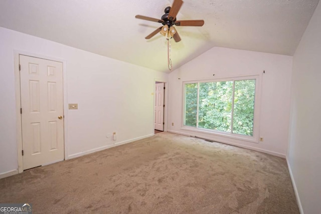 7472 Woods Ct, Lithonia, GA 30058 - spare room with carpet floors, vaulted ceiling, and ceiling fan