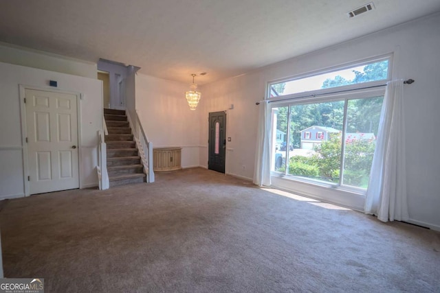 7472 Woods Ct, Lithonia, GA 30058 - unfurnished living room with a chandelier, carpet, and stairs