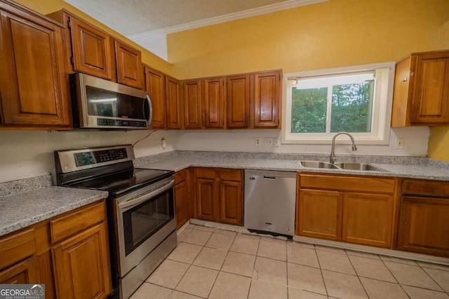7472 Woods Ct, Lithonia, GA 30058 - kitchen with stainless steel appliances, brown cabinetry, ornamental molding, light tile patterned floors, and light countertops