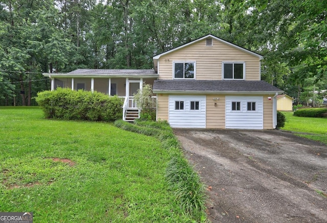 3681 Chestnut Lake Ct, Jonesboro, GA 30236 - tri-level home with asphalt driveway, a front lawn, a garage, and view of wooded area