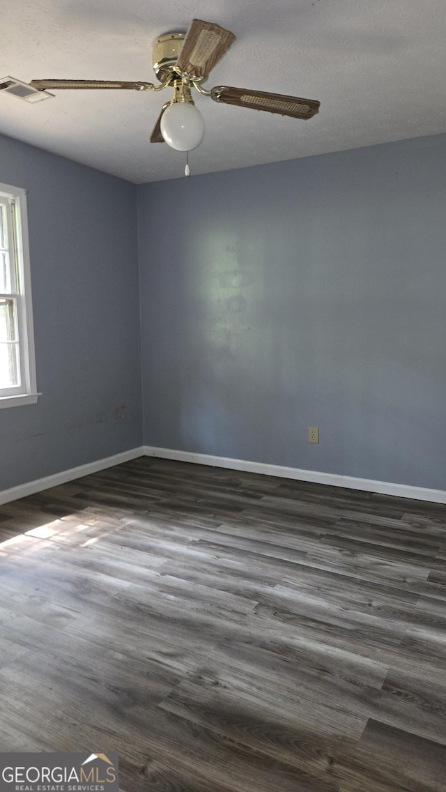 1448 SE Hillside Pl, Conyers, GA 30094 - spare room with dark wood finished floors and ceiling fan