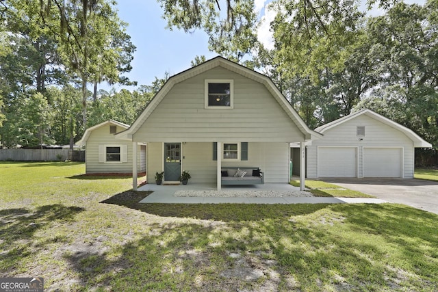 233 S Sheffield St, Kingsland, GA 31548 - colonial inspired home with a gambrel roof, an outbuilding, and a garage