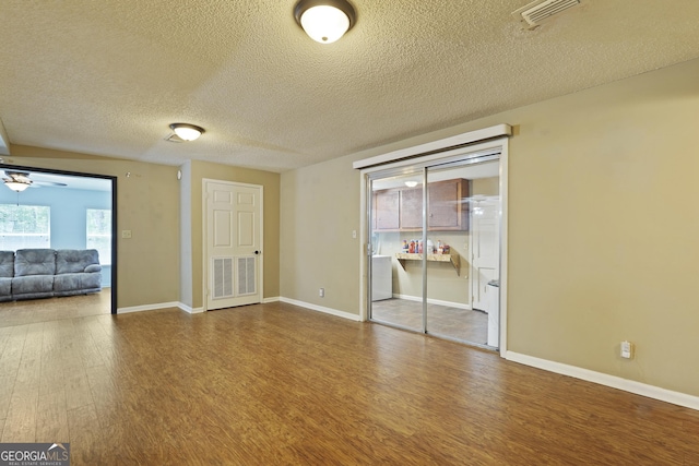 233 S Sheffield St, Kingsland, GA 31548 - empty room featuring wood finished floors, a textured ceiling, and ceiling fan