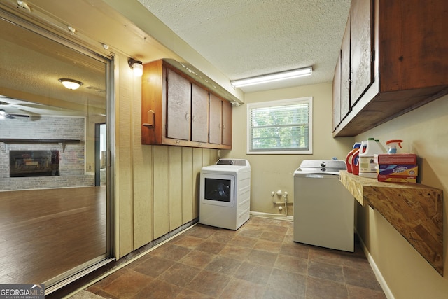233 S Sheffield St, Kingsland, GA 31548 - washroom featuring washer and clothes dryer, a textured ceiling, and a fireplace
