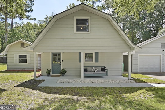 233 S Sheffield St, Kingsland, GA 31548 - colonial inspired home with a gambrel roof, a front lawn, a porch, and asphalt driveway