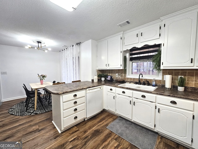164 Turner Creek Dr, Hampton, GA 30228 - kitchen featuring dishwasher, dark countertops, a peninsula, backsplash, and a textured ceiling