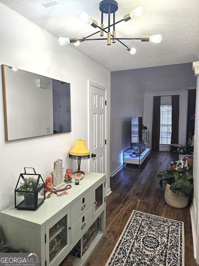 164 Turner Creek Dr, Hampton, GA 30228 - living room featuring a textured ceiling, a chandelier, and dark wood-style flooring
