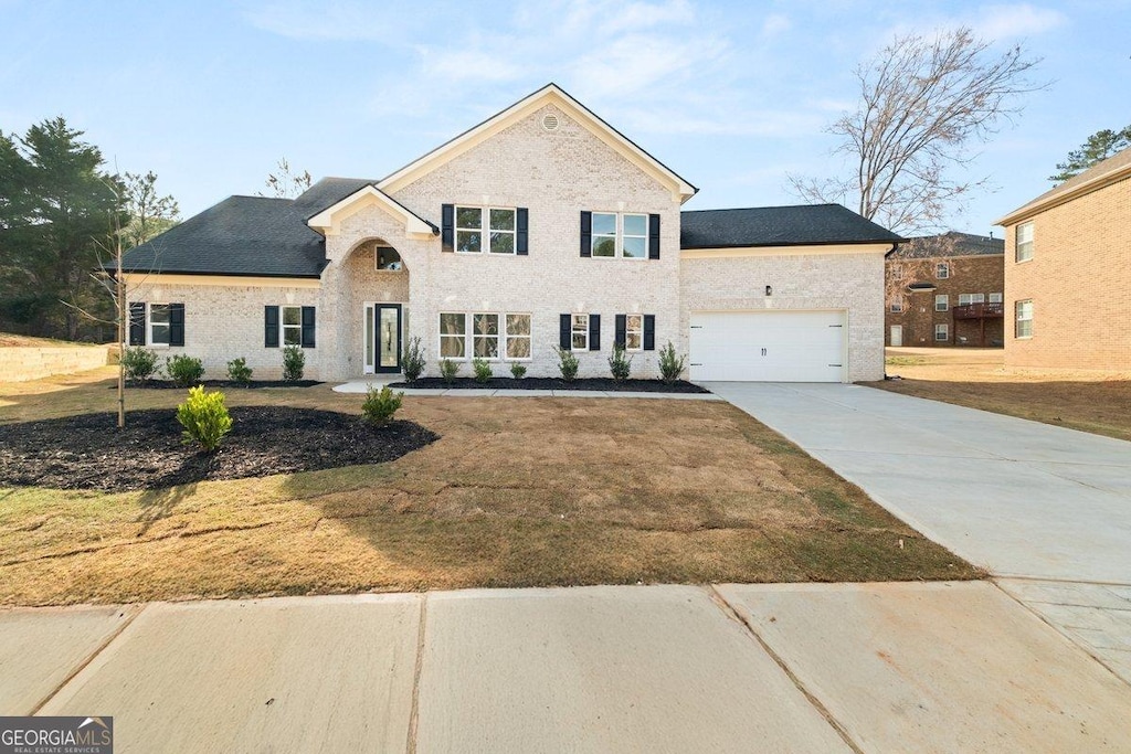 4647 Lantern Ct, Lithonia, GA 30038 - view of front facade with concrete driveway, a garage, a front lawn, and brick siding