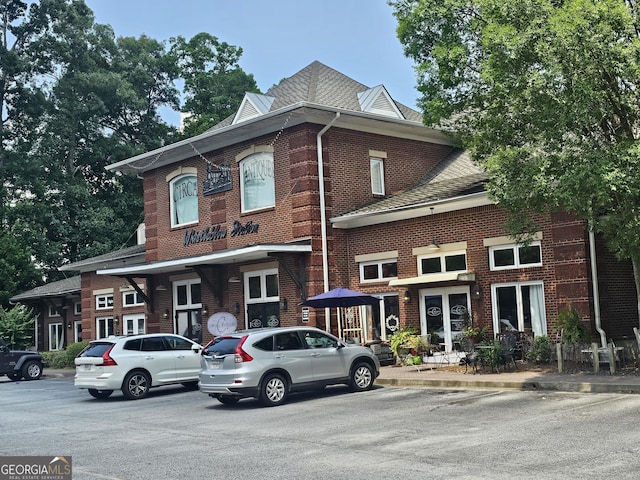 200 Chaparral Trce, Tyrone, GA 30290 - townhome / multi-family property featuring french doors, a shingled roof, brick siding, and uncovered parking
