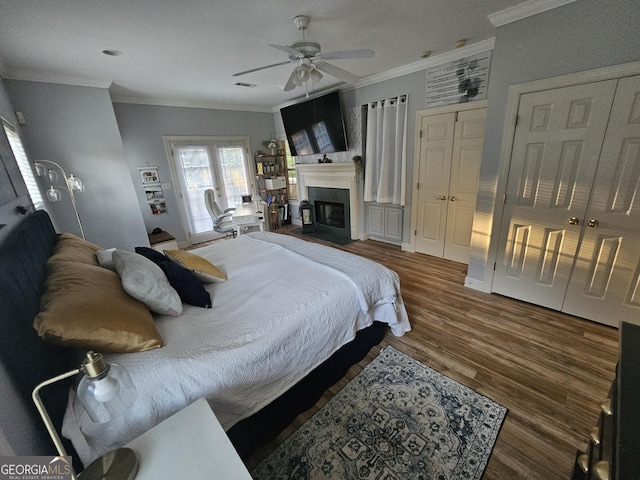 200 Chaparral Trce, Tyrone, GA 30290 - bedroom featuring ornamental molding, wood finished floors, a fireplace with flush hearth, two closets, and a ceiling fan
