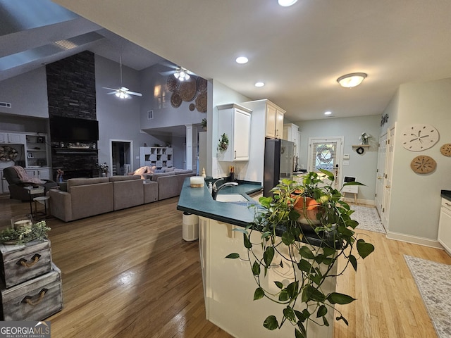 200 Chaparral Trce, Tyrone, GA 30290 - kitchen with freestanding refrigerator, dark countertops, light wood-type flooring, ceiling fan, and recessed lighting