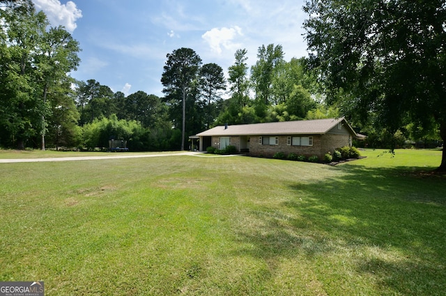 68 Archie Ln, Pine Mountain, GA 31822 - ranch-style house featuring a front lawn and view of wooded area