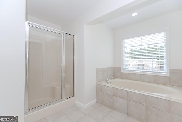 2023 Jameson Cir, Lawrenceville, GA 30043 - bathroom with a garden tub, a shower stall, and tile patterned floors