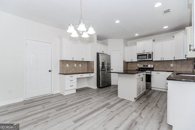 2023 Jameson Cir, Lawrenceville, GA 30043 - kitchen featuring stainless steel appliances, dark countertops, a kitchen island, white cabinetry, and recessed lighting