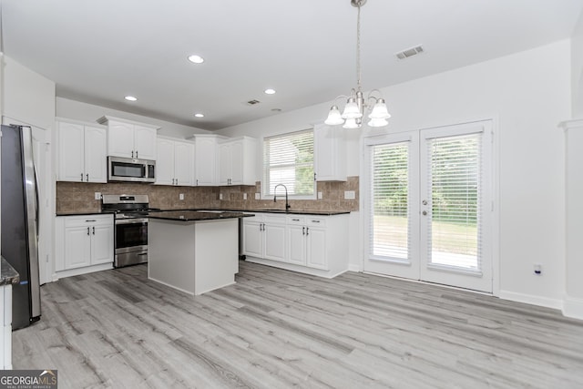 2023 Jameson Cir, Lawrenceville, GA 30043 - kitchen with stainless steel appliances, dark countertops, white cabinets, tasteful backsplash, and recessed lighting