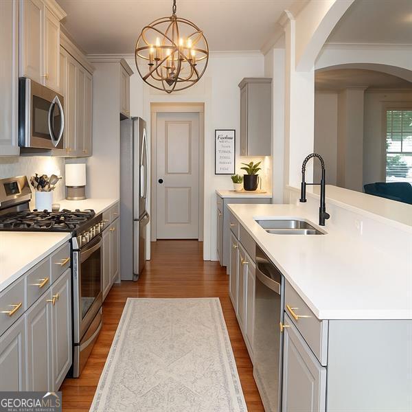 730 Midway, Canton, GA 30114 - kitchen with stainless steel appliances, gray cabinets, arched walkways, wood finished floors, and a chandelier