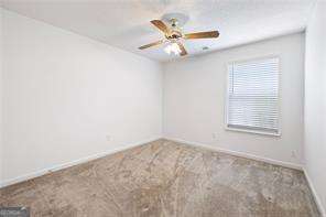 4527 Baker Grove Rd NW, Acworth, GA 30101 - spare room featuring carpet flooring and ceiling fan