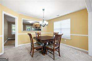4527 Baker Grove Rd NW, Acworth, GA 30101 - dining area with a chandelier and baseboards