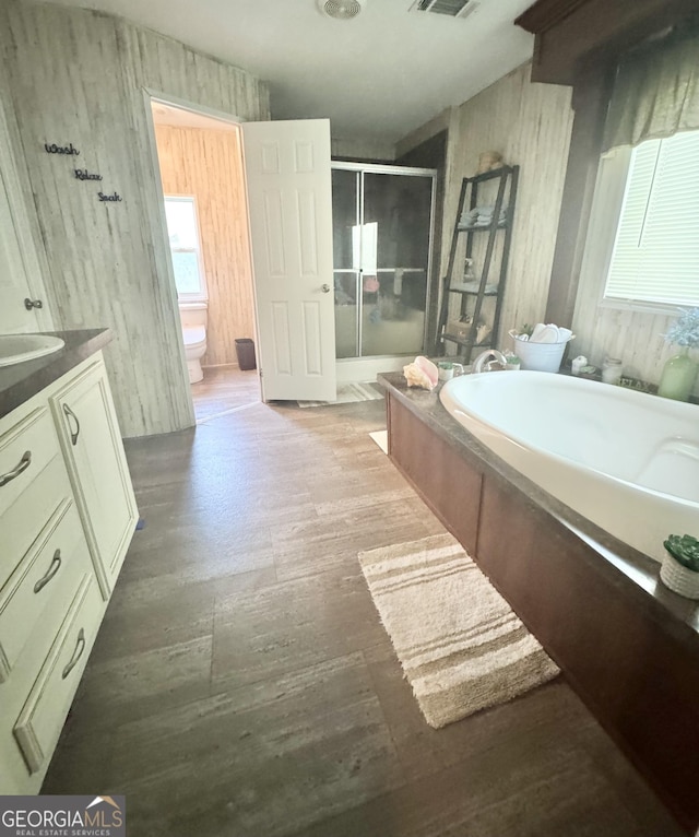 92 Graham Ln, Claxton, GA 30417 - full bathroom with a stall shower, a bath, vanity, and wood finished floors