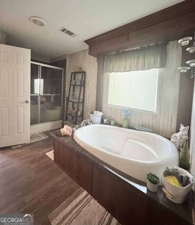 92 Graham Ln, Claxton, GA 30417 - bathroom with a bath, a stall shower, wood finished floors, and wood walls