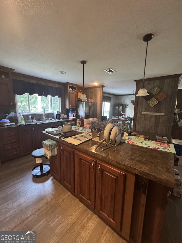 92 Graham Ln, Claxton, GA 30417 - kitchen featuring stainless steel refrigerator with ice dispenser, pendant lighting, and a kitchen island