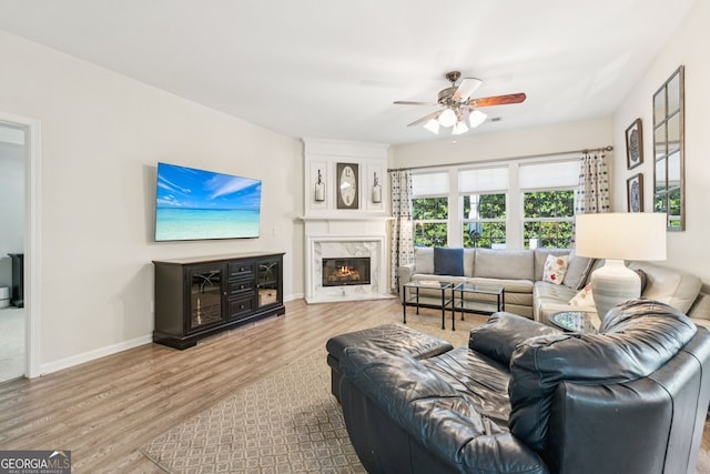 3804 Tattenhall Dr, Cumming, GA 30040 - living area featuring wood finished floors, a ceiling fan, and a fireplace