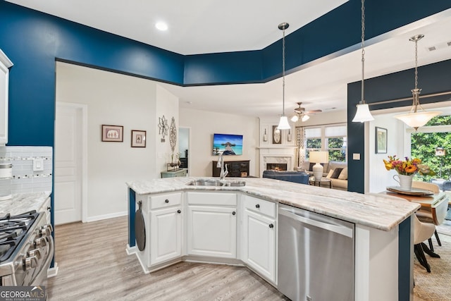 3804 Tattenhall Dr, Cumming, GA 30040 - kitchen featuring stainless steel appliances, a ceiling fan, a high end fireplace, light wood-type flooring, and recessed lighting