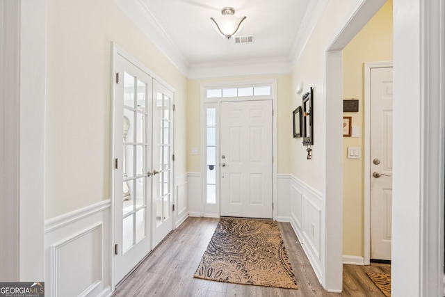 3804 Tattenhall Dr, Cumming, GA 30040 - foyer entrance with a wainscoted wall, a decorative wall, wood finished floors, and crown molding