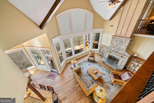 1043 Deer Run Rdg, Jasper, GA 30143 - living room featuring wood finished floors, high vaulted ceiling, ceiling fan, and a stone fireplace