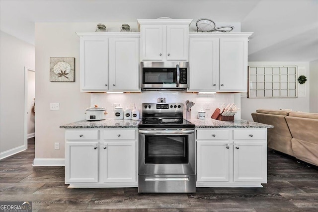93 Oakdale Way, Temple, GA 30179 - kitchen featuring appliances with stainless steel finishes, white cabinets, light stone counters, and decorative backsplash