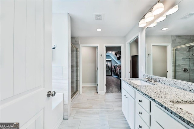 93 Oakdale Way, Temple, GA 30179 - full bathroom featuring a stall shower, a walk in closet, double vanity, recessed lighting, and marble look tile flooring