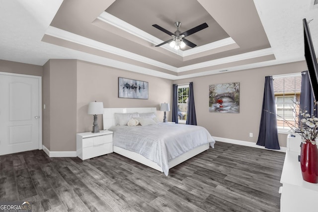 499 Running Doe Ct, Suwanee, GA 30024 - bedroom with a raised ceiling, dark wood-style flooring, crown molding, and a ceiling fan
