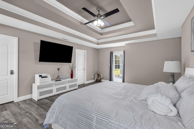 499 Running Doe Ct, Suwanee, GA 30024 - bedroom featuring a tray ceiling, wood finished floors, ornamental molding, and a ceiling fan