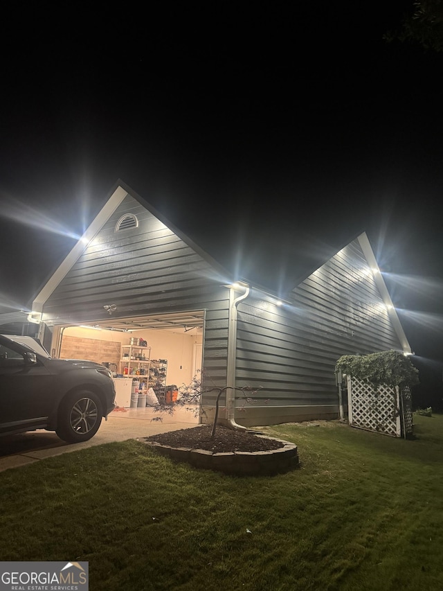 499 Running Doe Ct, Suwanee, GA 30024 - garage at twilight featuring a yard