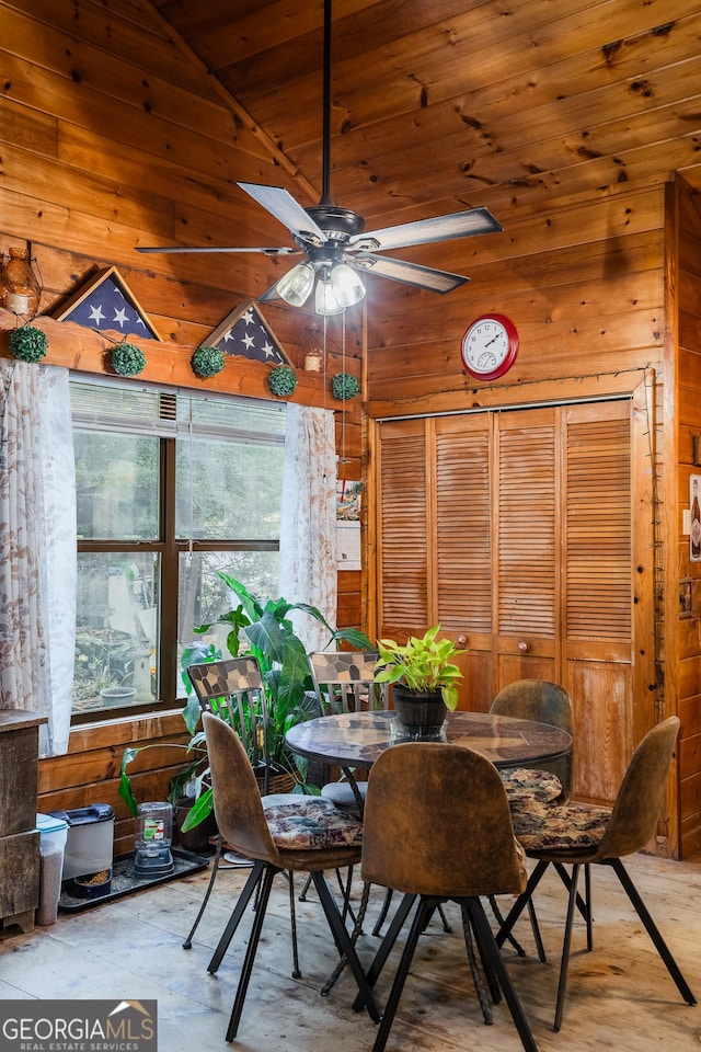 12 Scott Dr, Ellijay, GA 30540 - dining space with wood walls, ceiling fan, concrete floors, wood ceiling, and high vaulted ceiling
